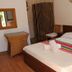 Azzurro Di Boracay Resort room in Boracay with queen bed, wicker desk, and tropical wall decor