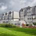 H+ Hotel Wiesbaden Niedernhausen in Niedernhausen with gray gabled buildings and landscaped lawn