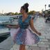 Atlantica Eleon Grand Resort in Tragaki: woman in a dress by the waterfront and small boats