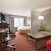 Country Inn & Suites By Radisson Dfw-Arpt S Irving guest room with sofa, desk, and bed in Irving
