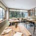 Dining room at Falkensteiner Hotel Antholz in Rasun Anterselva with large windows and forest views