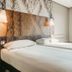ibis Caen Porte de Bretagne guest room with two single beds and window in Bretteville-sur-Odon