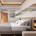 Mediterranean Hotel, Rhodes: modern guest room with king bed, wall-mounted TV, and mirrored accent wall