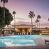 The Scott Resort & Spa in Scottsdale with a palm-lined resort pool at sunset