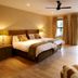 Sandton Lodge Rivonia in Johannesburg guest room with twin beds, balcony doors, and ceiling fan
