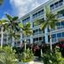 Palm Heights, North Side: tropical beachfront hotel facade with palm trees and a pool