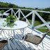 Yugawara Bay Mandarin House in Yugawara, terrace with round tables and chairs overlooking greenery