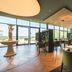 Hotel Gut Matheshof restaurant with large windows, wood floors, and modern seating in Ensdorf, Bayern