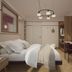 Hotel Taormina in Bardolino guest room with bed, desk, wall-mounted TV and pendant light