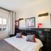 Hostal Athenas room in Sant Adrià de Besòs with twin bed, wall lights and window view