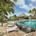 Paradise Cove Boutique Hotel in Cap Malheureux with a curved infinity pool, loungers and palm trees