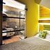 Karczma Rzym in Bydgoszcz room with bed, colorful pillows, and glass bathroom partition