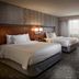 Courtyard by Marriott Fayetteville guest room with two beds and large window in Fayetteville