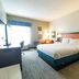 Hampton Inn Atlanta/Peachtree City guest room with king bed, desk, and window seating in Peachtree City