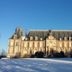 B&B Chateau de Villersexel in Villersexel, a chateau hotel viewed from a snowy lawn