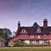 Ravenwood Hall Hotel in Bury St. Edmunds, red-brick country house exterior at dusk