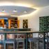 Posadas De España Cartagena bar and lounge with high stools, curved counter, and ambient ceiling lights