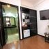 Hanoi Crystal Hotel in Hanoi room with TV, sofa, wardrobe, and wooden floor