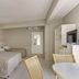 Canasvieiras Hotel in Florianopolis guest room with two beds, small dining table, and TV
