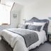 La Villa Bel Air in Flamanville: bright guest room with double bed, desk, TV, and window with curtains