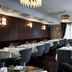 Boutique Hotel Yöpuu in Jyväskylä restaurant with set dining tables and upholstered chairs