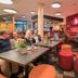 Best Western Plus Kurhotel an der Obermaintherme lounge with tables, stools and guests in Bad Staffelstein