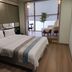 South Garden Hotel Chongqing guest room with king bed and sitting area