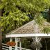 Hudson Manor Bed & Breakfast in Watkins Glen with a gazebo surrounded by trees and hanging flower baskets