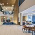 Delta Hotels by Marriott Ashland Downtown lobby with high ceilings, hanging lights, seating areas and large windows