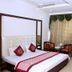 Hotel Park Plaza, Chandigarh guest room with king bed, canopy frame, and curtained window seating area