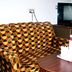 Hotel Buddha International in Bodh Gaya room with patterned sofa, table, and TV
