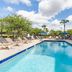 Holiday Inn Express & Suites Orange City - Deltona By IHG pool area with lounge chairs and palm trees