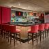 Sheraton Suites Akron Cuyahoga Falls bar with red stools and large windows overlooking water