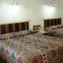Mar de Cortez in Cabo San Lucas: simple guest room with two beds, bedside table and wall lamps
