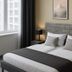 Hotel Stadt Hamburg in Saarbruecken room with double bed, bedside lamps and city-view window