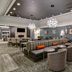 Homewood Suites by Hilton Burlington lobby lounge with seating area and chandeliers