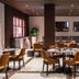 Worldhotel Cristoforo Colombo Milan restaurant with mustard chairs and polished marble floor