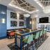 Hampton Inn & Suites Raleigh-Durham Airport-Brier Creek meeting room with bar seating and colorful wall art in Raleigh