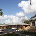 Prince of Wales Motel in Lake Wales with motel office sign, palm trees, parked car and blue sky