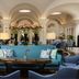 The Phoenicia Malta in Valletta, elegant hotel lounge with arched ceilings, blue seating, and floral arrangement