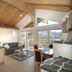 Appartement Sonnengarten in Ramsau am Dachstein living area with kitchen, sofa, dining table and mountain view