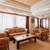 Grand View International Hotel, Liaoyang: elegant suite living room with sofa set, coffee table, and large windows