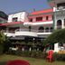 Hotel Buddha International in Bodh Gaya, white-and-red hotel facade with balconies and garden