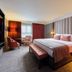 Hotel Killarney, Killarney guest room with king bed, seating area, and large window