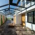 Bij Jef, Den Hoorn: glass-roofed indoor corridor with seating and countryside views