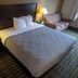 Quality Inn Noblesville-Indianapolis guest room with queen bed, sofa, and bedside lamps
