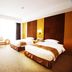Jinhu Hotel Wuxi guest room with two twin beds, TV, desk, and large window with curtains