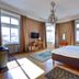First Hotel City Eskilstuna guest room with bed, chandelier, windows and TV in Eskilstuna