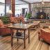 The Historic Crags Lodge in Estes Park lounge with stone fireplace, leather chairs and mountain lodge decor