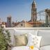 Judita Palace Heritage Hotel in Split rooftop terrace with white sofa, plants, and city church towers